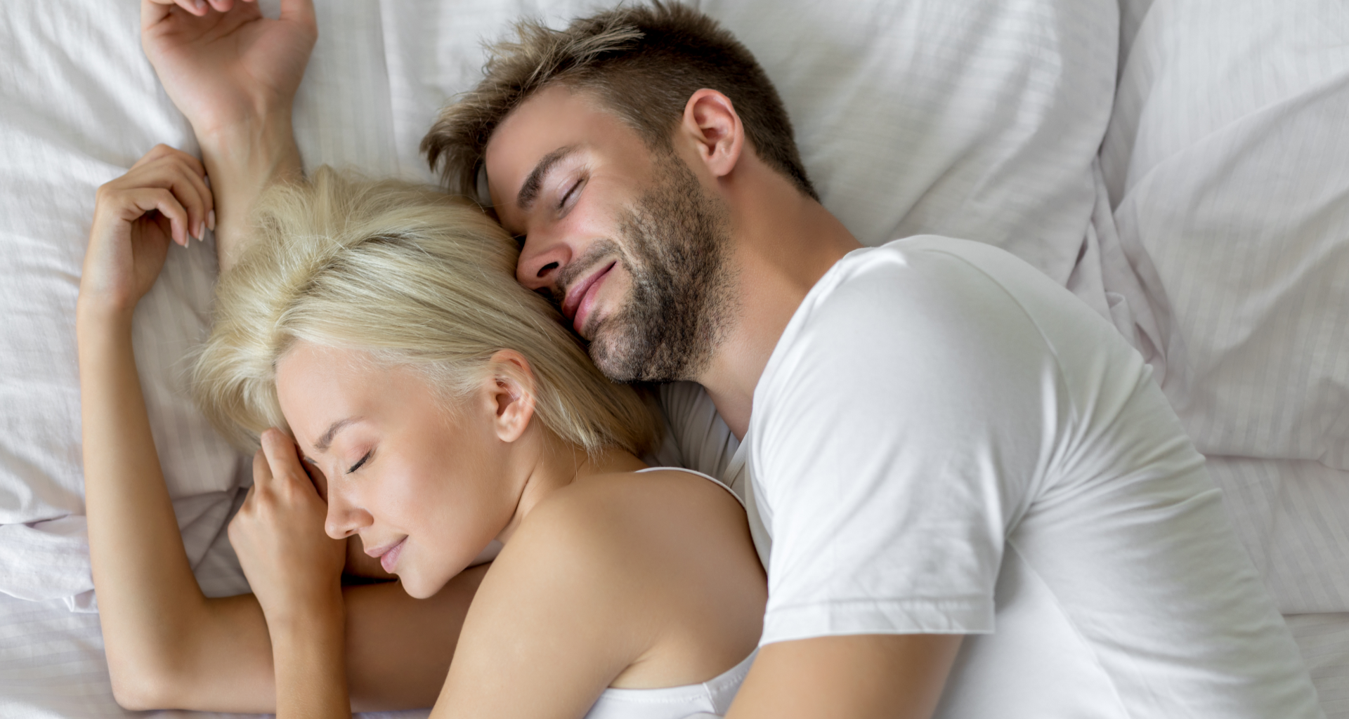 A young couple sleeping peacefully in bed